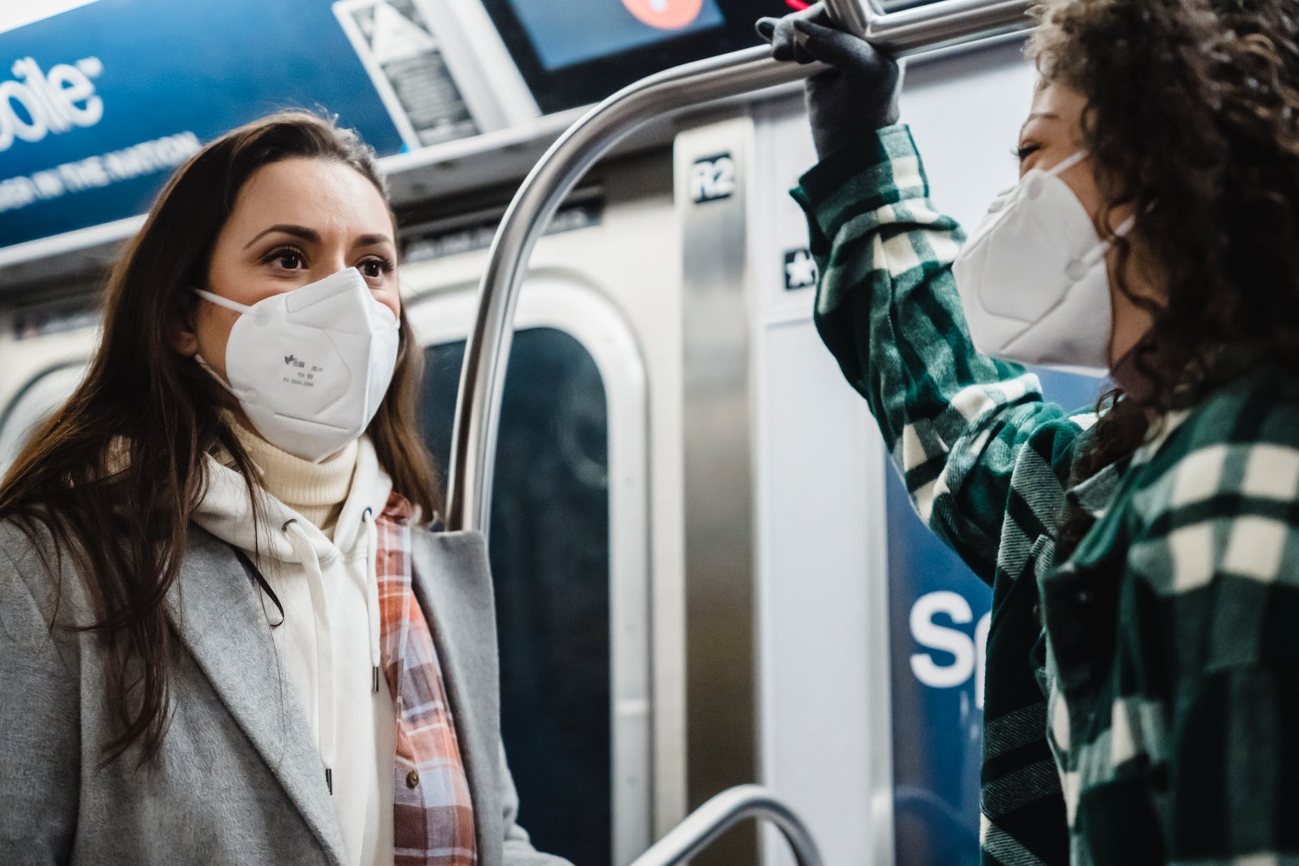 multiethnic women in medical masks in subway wagon